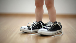 toddler-wearing-big-shoes_TS_104631847